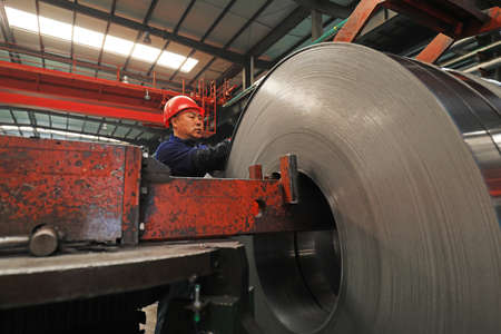 LUANNAN COUNTY, Hebei Province, China - March 25, 2020: Workers are busy on the strip production line in a factory.のeditorial素材
