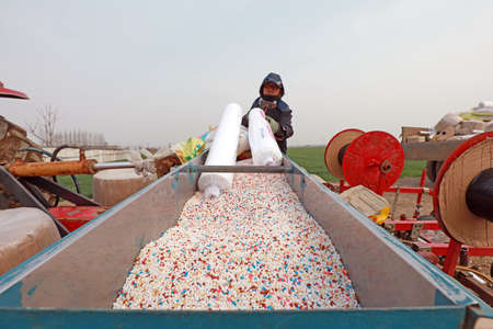 LUANNAN COUNTY, Hebei Province, China - March 31, 2020: Farmers are adding water, fertilizer and seeds to the machinery to prepare for sowing.のeditorial素材