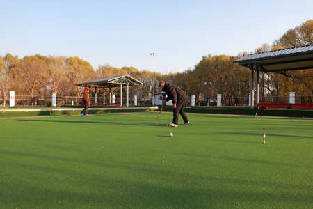 LUANNAN COUNTY, Hebei Province, China - November 19, 2020: An octogenarian is playing gateball to keep fit in the parkのeditorial素材