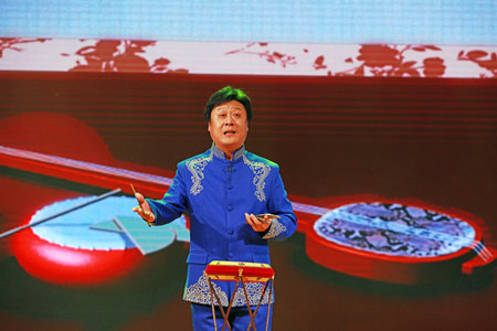 LUANNAN COUNTY, Hebei Province, China - April 28, 2019: A man is performing a drum book on the stage.のeditorial素材