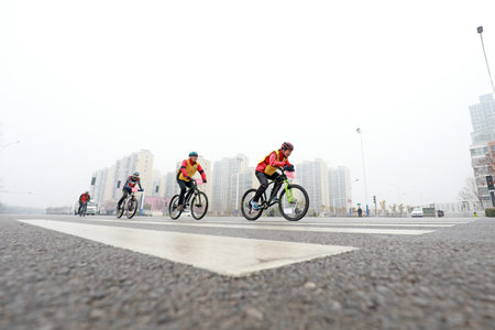 LUANNAN COUNTY, Hebei Province, China - November 23, 2019: Cyclists are trying to move forward, on a...