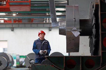 LUANNAN COUNTY, Hebei Province, China - March 26, 2020: Workers are busy on the strip production line in an iron and steel company.のeditorial素材