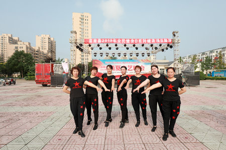 LUANNAN COUNTY, Hebei Province, China - August 8, 2019: Women's fitness dance performance in the park square.のeditorial素材