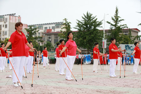 LUANNAN COUNTY, Hebei Province, China - August 8, 2019: Old people's aerobics performance in the park square.のeditorial素材