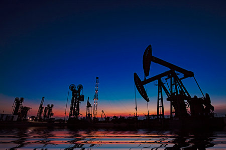 Oil pumping machinery in operation, crude oil extraction scene in the night, North Chinaの写真素材