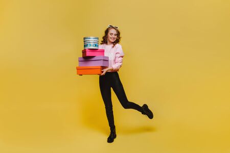 Beautiful young woman holding an big gift box. Attractive elegant young woman holding gift box over...