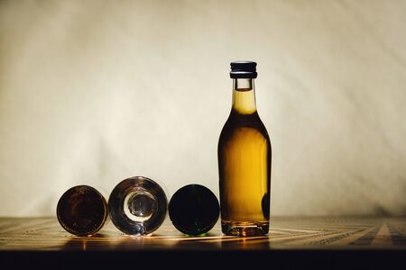 different alcohol bottles are on the table on a light backgroundの写真素材