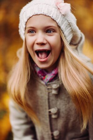 Charming little girl laughs - happy girl. charming autumnの写真素材