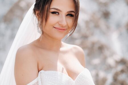 Beautiful bride in a wedding dress on top of the salt mountains. A stunning young bride with curly...
