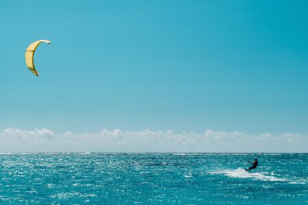 A man paragliding on Le Morne beach, Mauritius, Indian ocean on the island of Mauritius.の写真素材