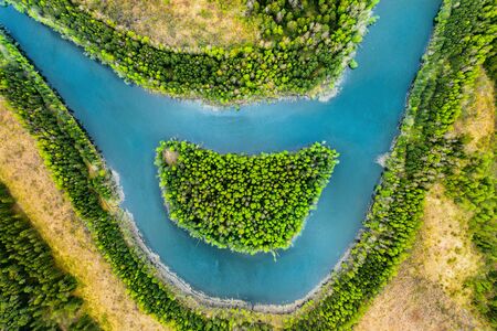 View of the river and the island like a smile from a bird's eye view. Forest zone with a river in Belarus.の写真素材
