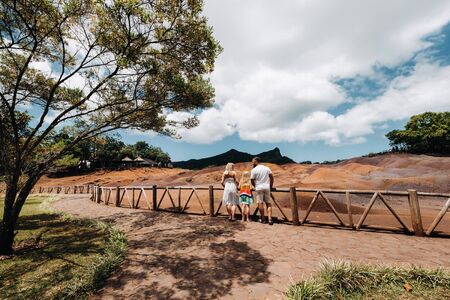 family against the background of seven-Colored lands in Mauritius, nature reserve, Chamarel Sands.Mauritius island.の写真素材