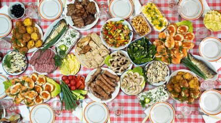 A lot of different food on the Banquet table.A large number of prepared dishes on the table.Holiday at the table.の写真素材