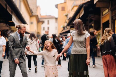 A happy family of three walking in Florence.Family walk of the family in Italy.Tuscany.の写真素材