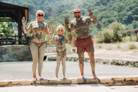 A happy family of three takes mud baths at a resort in Turkey.Family Wellness in therapeutic mud.Turkey.の写真素材