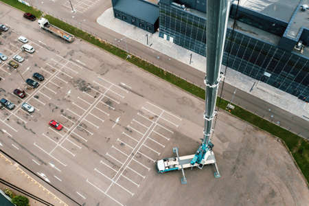view from the height of the Car heavy crane that stands open in the Parking lot and ready to work....