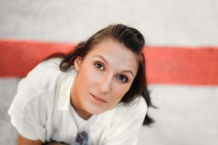 a girl in white clothes on the background of the national flag of Belarus white red white.