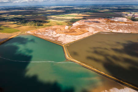 Mountains of products for the production of potash salt and artificial turquoise reservoirs. Salt mountains near the city of Soligorsk. Production of fertilizers for the Land. Belarus.の写真素材