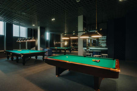 Billiard table with green surface and balls in the billiard club.Pool Game.