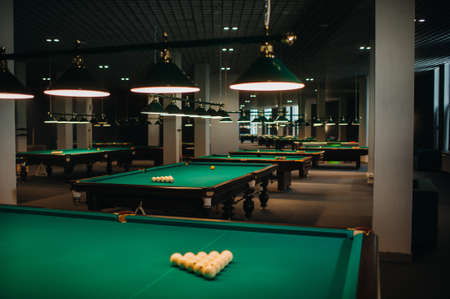 Billiard table with green surface and balls in the billiard club