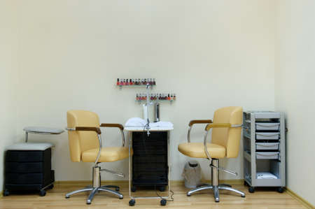 place for a manicure in a beauty salon in bright colors.Two chairs and a table in the nail care room.の写真素材