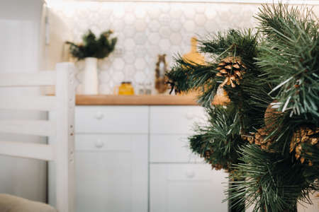 Christmas table decoration in the kitchen, Banquet table with glasses before serving food, close-up of the Christmas dinner table with seasonal decorations, crystal glasses and decorative deer.の写真素材