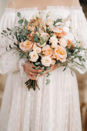 wedding bouquet with peonies in the hands of the bride under the veil.Morning of the bride.の写真素材
