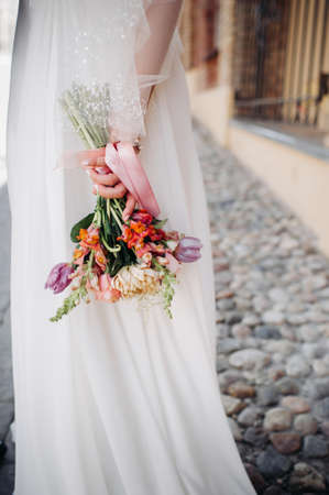 wedding bouquet with peonies in the hands of the bride under the veil.Morning of the bride.の写真素材