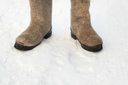 close up of felt boots standing in the snow