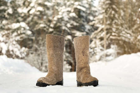 close up of felt boots standing in the snowの写真素材