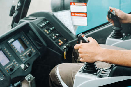 Close up of a hand holding the control stick and ready to work in the truck crane the largest truck crane for challenging tasksの写真素材