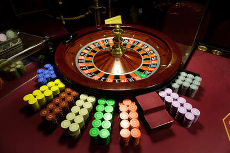 close-up chips and roulette at the casino on the red table.の写真素材