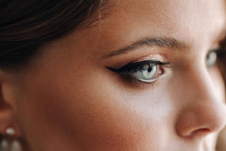 Close-up portrait of a luxurious bride in a wedding dress in the morning in her interiorの写真素材