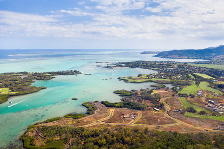 Aerial picture of the east coast of Mauritius Island. Beautiful lagoon of Mauritius Island shot from above. Boat sailing in turquoise lagoon.の写真素材