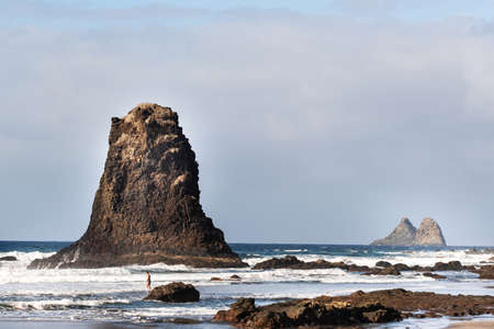 People on the sandy beach of Benijo on the island of Tenerife.Spain.の写真素材