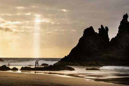 A couple of lovers on the sandy beach of Benijo on the island of Tenerife.Spain.の写真素材