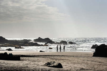 People on the sandy beach of Benijo on the island of Tenerife.Spain.の写真素材