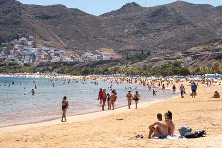 July 25, 2019 Tenerife, Spain, Canary Islands, People vacationing on the sandy beach of the island of Tenerife.のeditorial素材