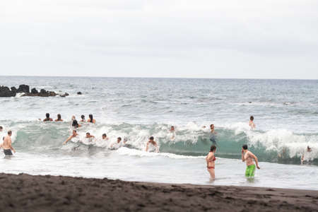 July 26, 2019 Tenerife, Spain, Canary Islands, People on the city beach of Puerto de la Cruz.のeditorial素材