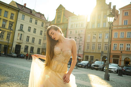 A bride in a wedding dress with long hair in the old town of Wroclaw. Wedding photo shoot in the center of an ancient city in Poland.Wroclaw, Poland.の写真素材