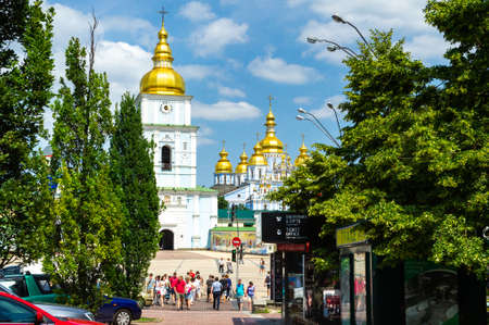 KIEV, UKRAINE-JUNE 18, 2018: Tourists on the street in the center of Kiev near the Church.