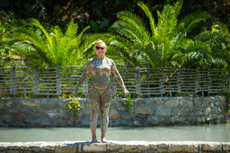 A girl takes a mud bath at a resort in Turkey.Health improvement in therapeutic mud.
