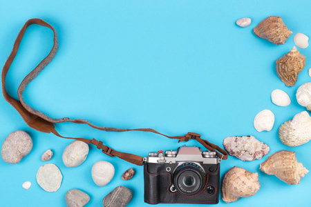 camera and seashells on a blue background.Background for the traveler.の写真素材