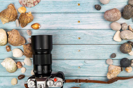 camera and seashells on a blue wooden background.Marine theme.の写真素材