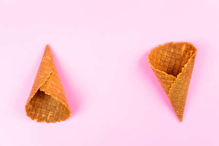Waffle empty ice cream cones on a colored pink background.の写真素材