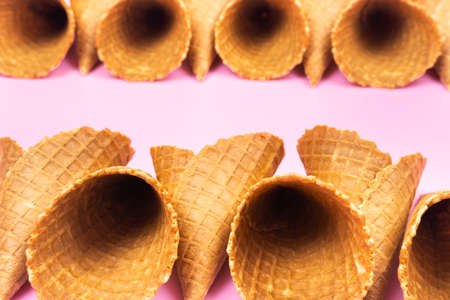 Empty waffle cones for ice cream on a pink background.の写真素材