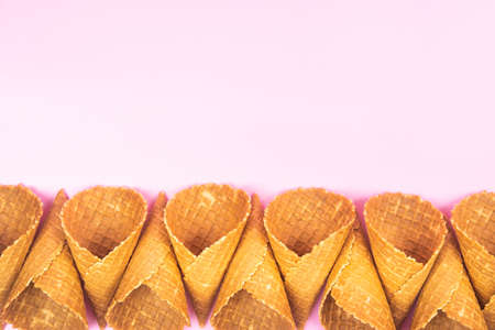Empty waffle cones for ice cream on a pink background.の写真素材