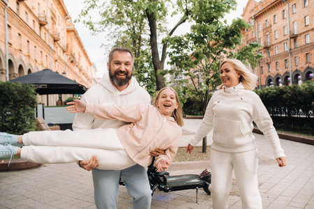 A happy family in white clothes walks around the city.A fun walkの写真素材