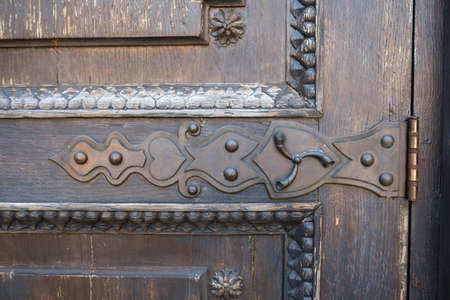 part of an old wooden door with a stained glass pattern.