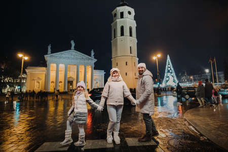 A family walks around the New Year's city of Vilnius.Lithuania.